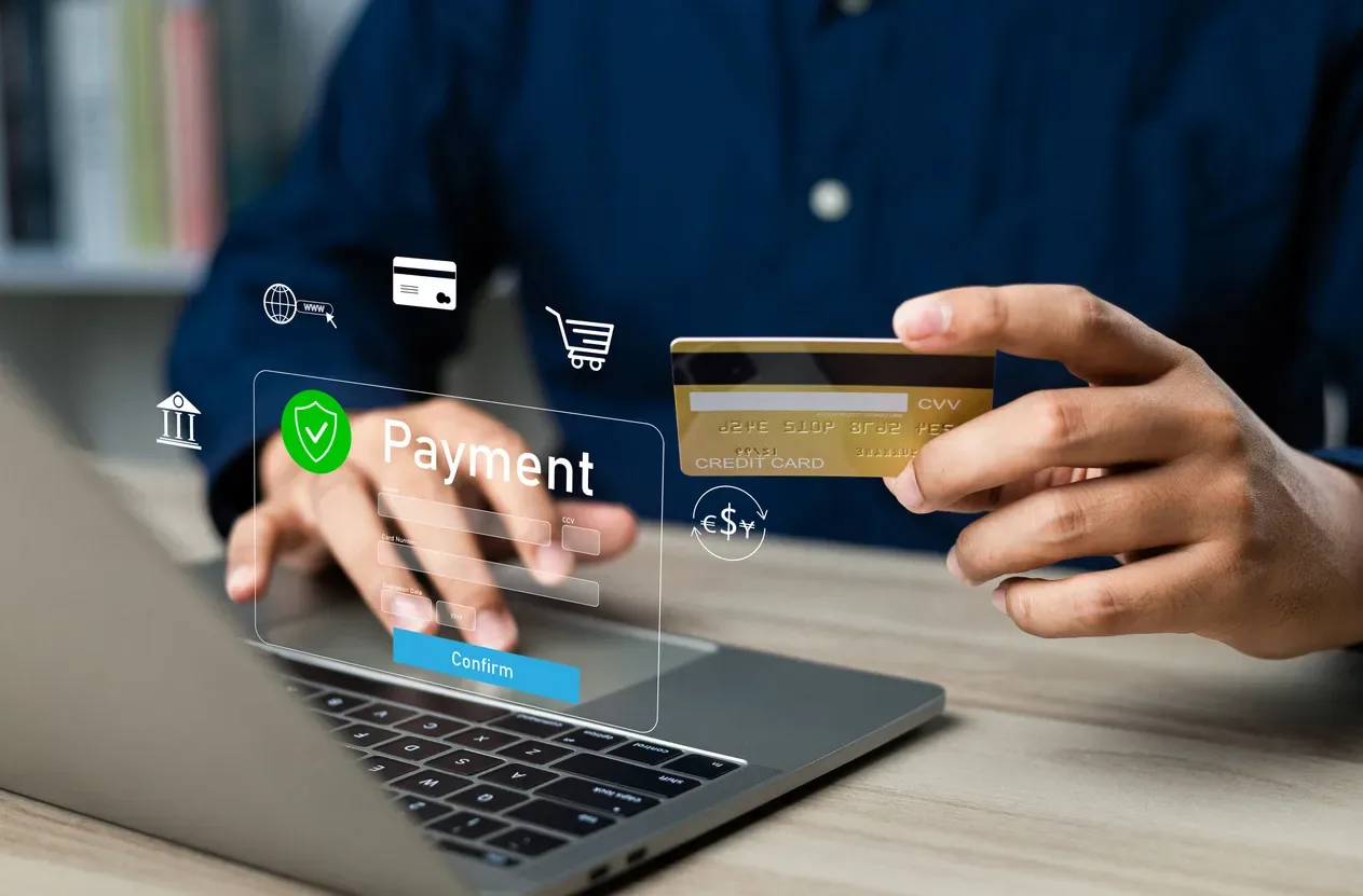 Player funding an online wallet with a card while a payment screen floats beside the laptop